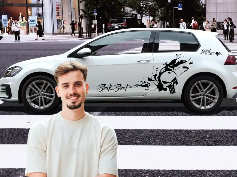 Sportlicher junger Mann vor seinem weißen VW Golf 7 mitten in der City mit dem Sticker-Motiv Skull in Schwarz